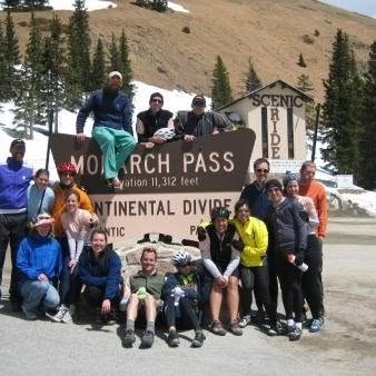The team gathered around the Monarch Pass sign on the Continental Divide, elevation 11,312 feet