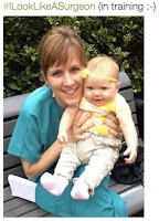 Heather Logghe in turquoise scrubs holding her baby daughter Sierra, captioned #ILookLikeASurgeon (in training)