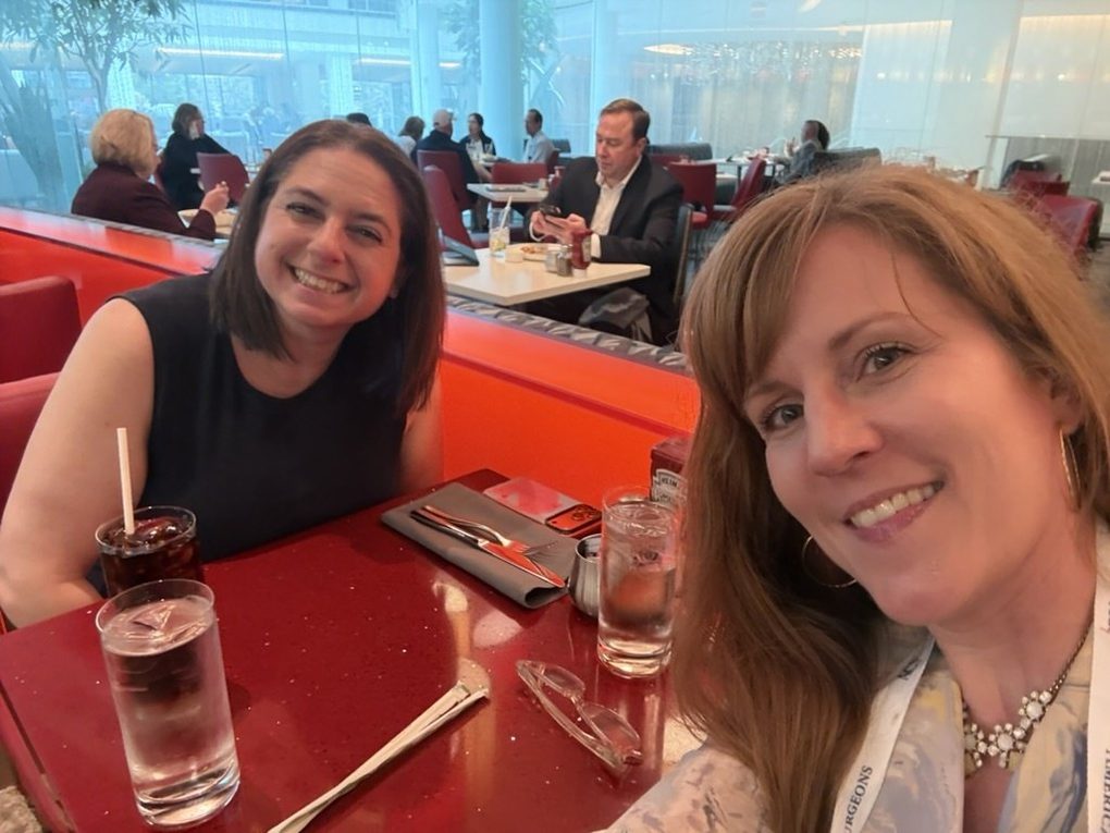 Heather and Dr. Lauren Nosanov smiling across a lunch table at the 2026 ACS Clinical Congress