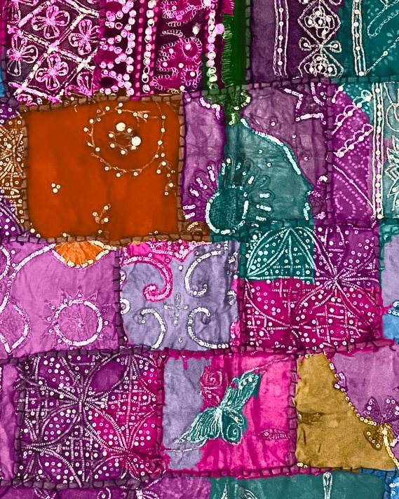 Patchwork of embroidered fabrics in fuchsia, purple, teal, and gold